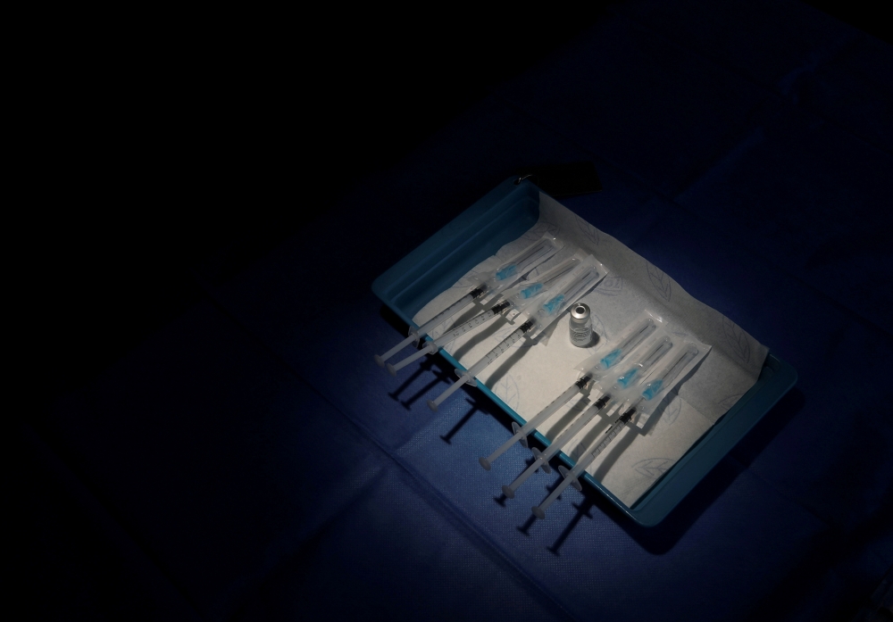 Syringes filled with a dose of the Pfizer-BioNTech coronavirus disease (COVID-19) vaccine are prepared at the CHIREC Delta Hospital in Brussels, Belgium January 21, 2021. REUTERS/Yves Herman/File Photo