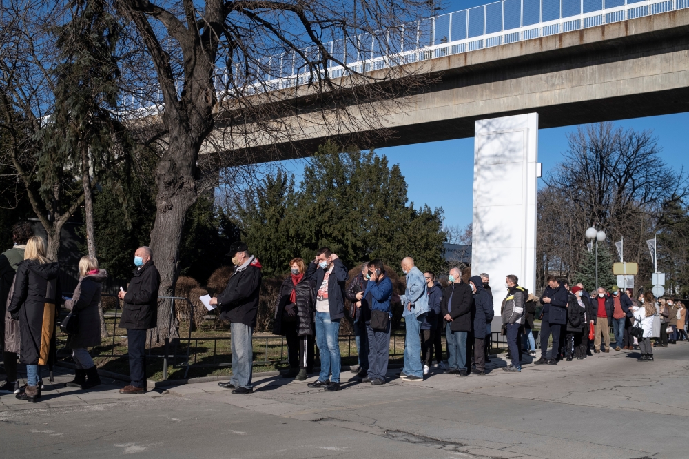 People wait in line to receive the Chinese Sinopharm vaccine as the country begins mass vaccination for the coronavirus disease (COVID-19), in Belgrade, Serbia, January 21, 2021. REUTERS/Marko Djurica