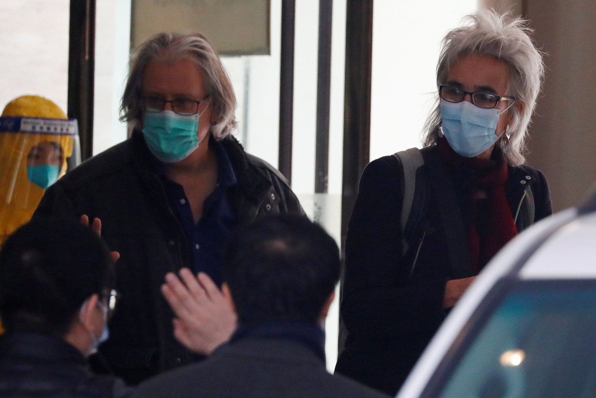 Members of the World Health Organisation (WHO) team tasked with investigating the origins of the coronavirus disease (COVID-19) pandemic leave their quarantine hotel in Wuhan, Hubei province, China January 28, 2021. REUTERS/Thomas Peter
