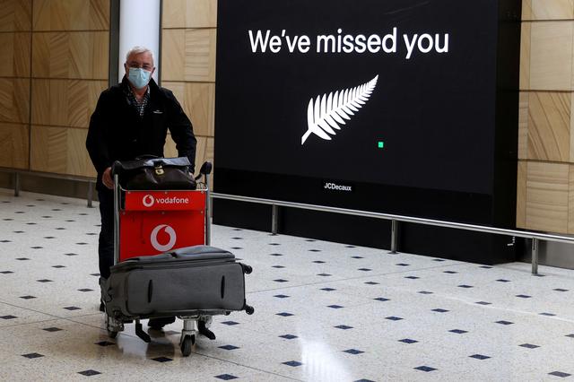 FILE PHOTO: A passenger arrives from New Zealand after the Trans-Tasman travel bubble opened overnight, following an extended border closure due to the coronavirus disease (COVID-19) outbreak, at Sydney Airport in Sydney, Australia, October 16, 2020. REUT