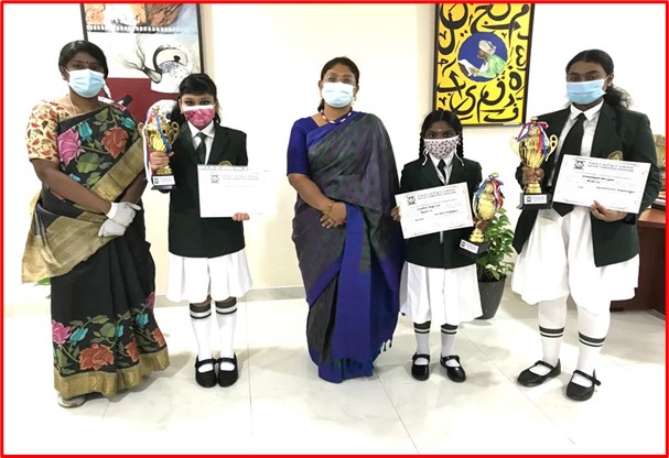 Winners posing with certificates and trophies. 