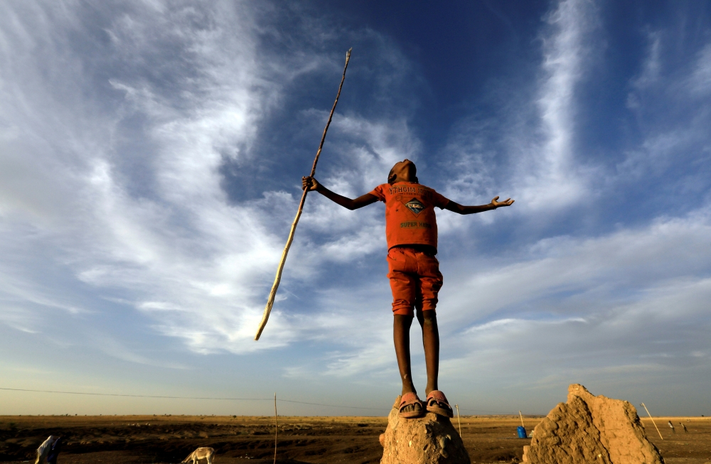 FILE PHOTO: An Ethiopian boy who fled the ongoing fighting in Tigray region, gestures in the Hamdayet village, in eastern Kassala state, Sudan December 15, 2020. Picture taken December 15, 2020. REUTERS/Mohamed Nureldin Abdallah