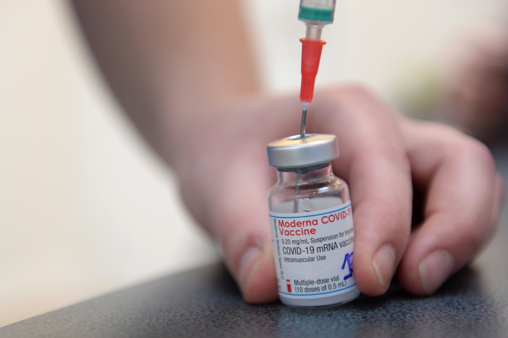 A medical worker prepares a syringe with a dose of the Moderna COVID-19 vaccine at a vaccination center in Brussels, as part of the coronavirus disease (COVID-19) vaccination campaign in Belgium, February 2, 2021. REUTERS/Johanna Geron