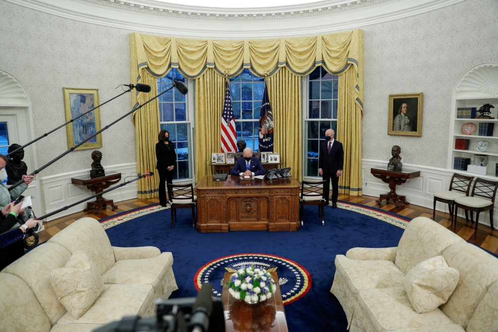 U.S. President Joe Biden prepares to sign executive orders on immigration at the White House in Washington, U.S., February 2, 2021. REUTERS/Tom Brenner