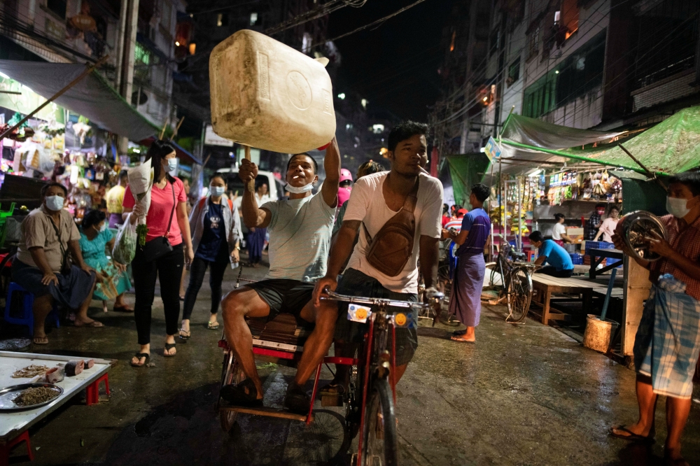 People attend a night protest against the military coup in Yangon, Myanmar February 5, 2021. REUTERS/Stringer