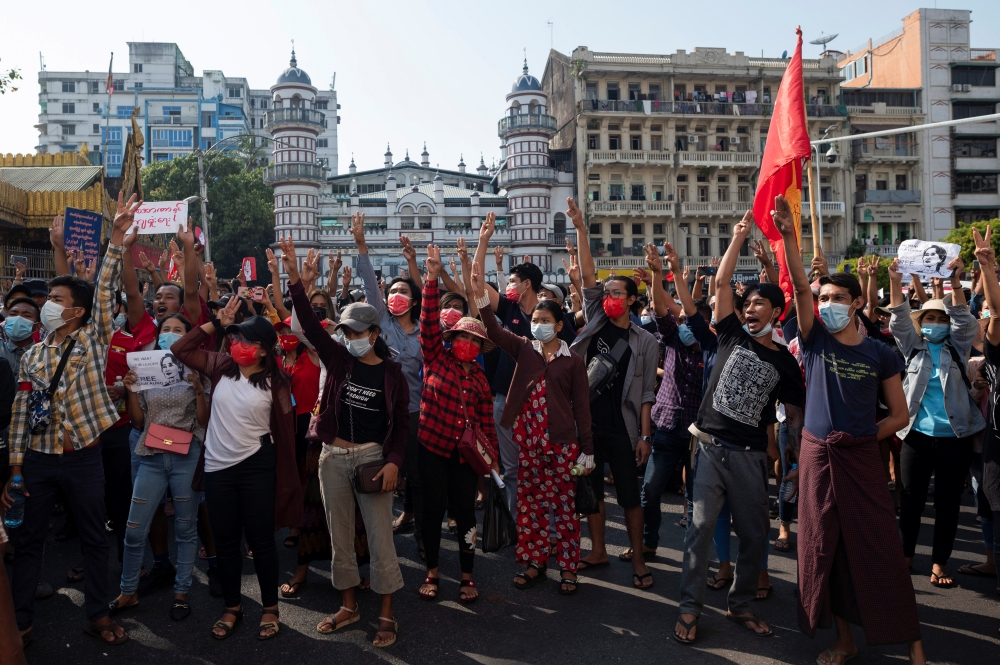People show the three-finger salute as they rally in a protest against the military coup and to demand the release of elected leader Aung San Suu Kyi, in Yangon, Myanmar, February 7, 2021. REUTERS/Stringer