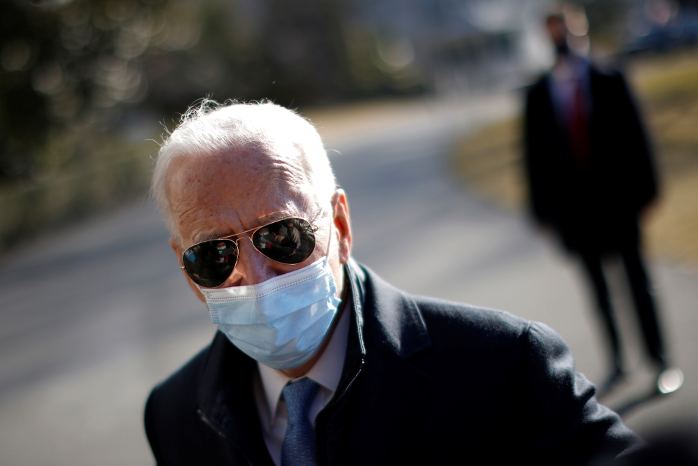 U.S. President Joe Biden talks to a reporter as he arrives on the South Lawn at the White House in Washington, U.S., February 8, 2021. REUTERS/Carlos Barria