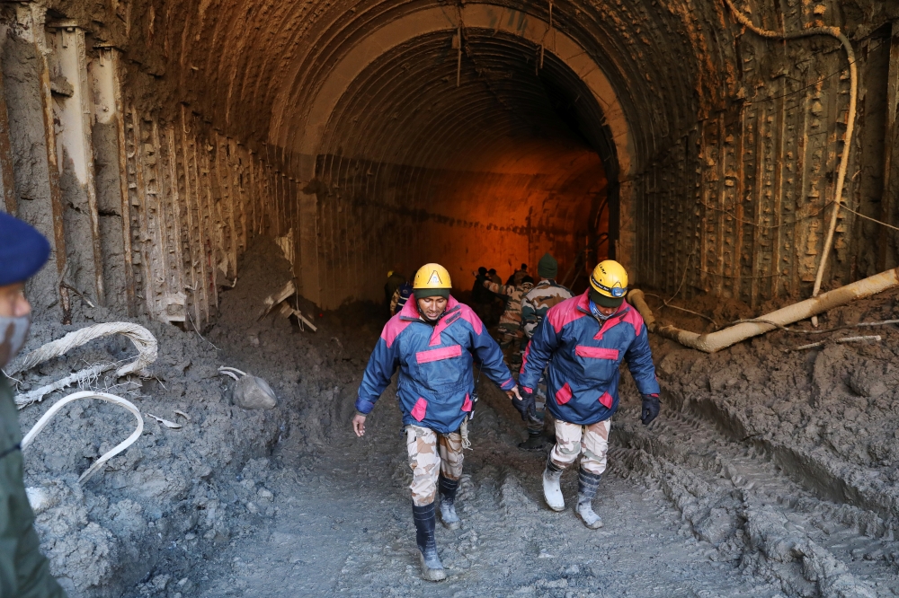 Members of a rescue team work inside a tunnel after a part of a glacier broke away in Tapovan, in the northern state of Uttarakhand, India, February 11, 2021. REUTERS/Anushree Fadnavis