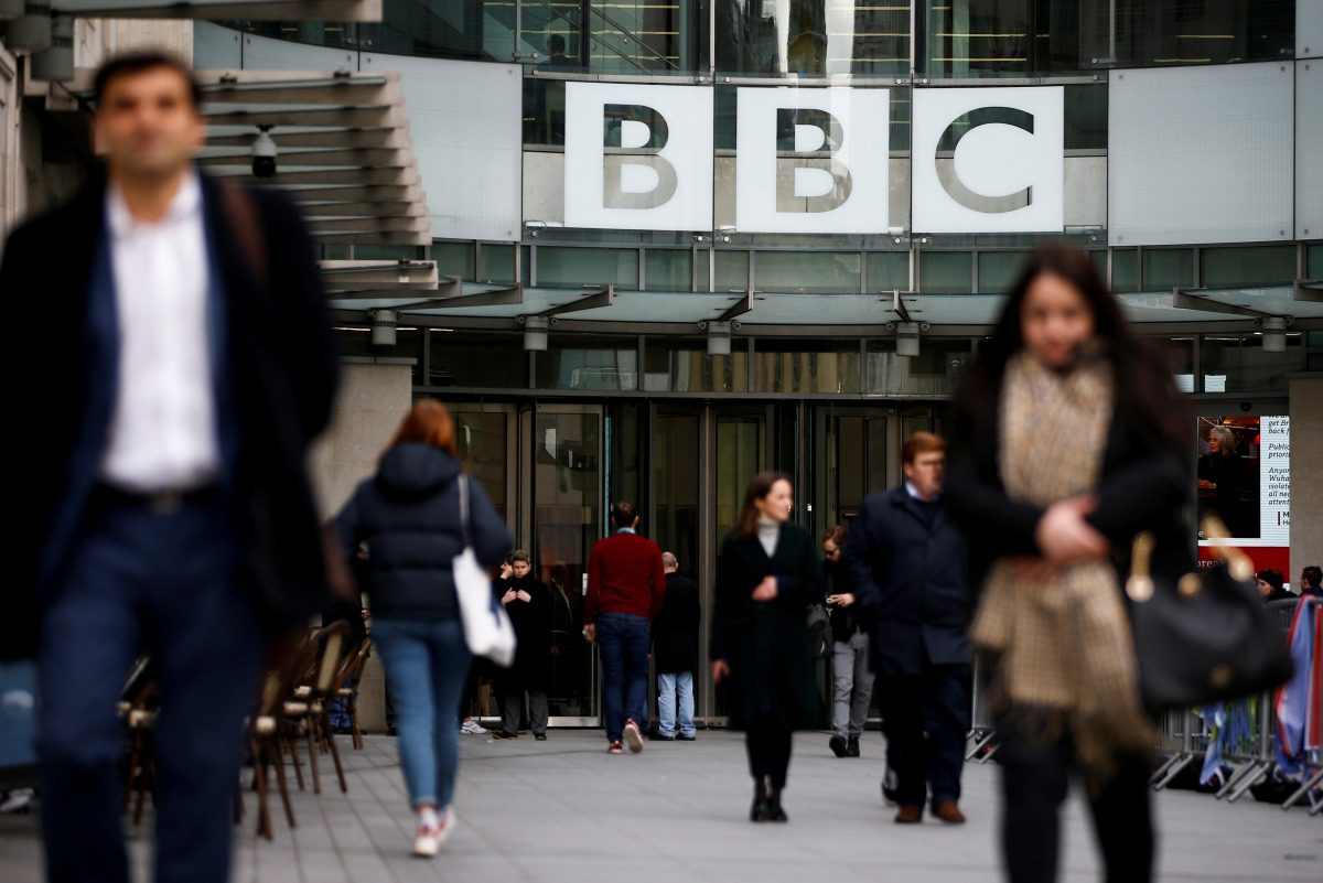 FILE PHOTO: Pedestrians walk past a BBC logo at Broadcasting House in London, Britain January 29, 2020. REUTERS/Henry Nicholls/File Photo
