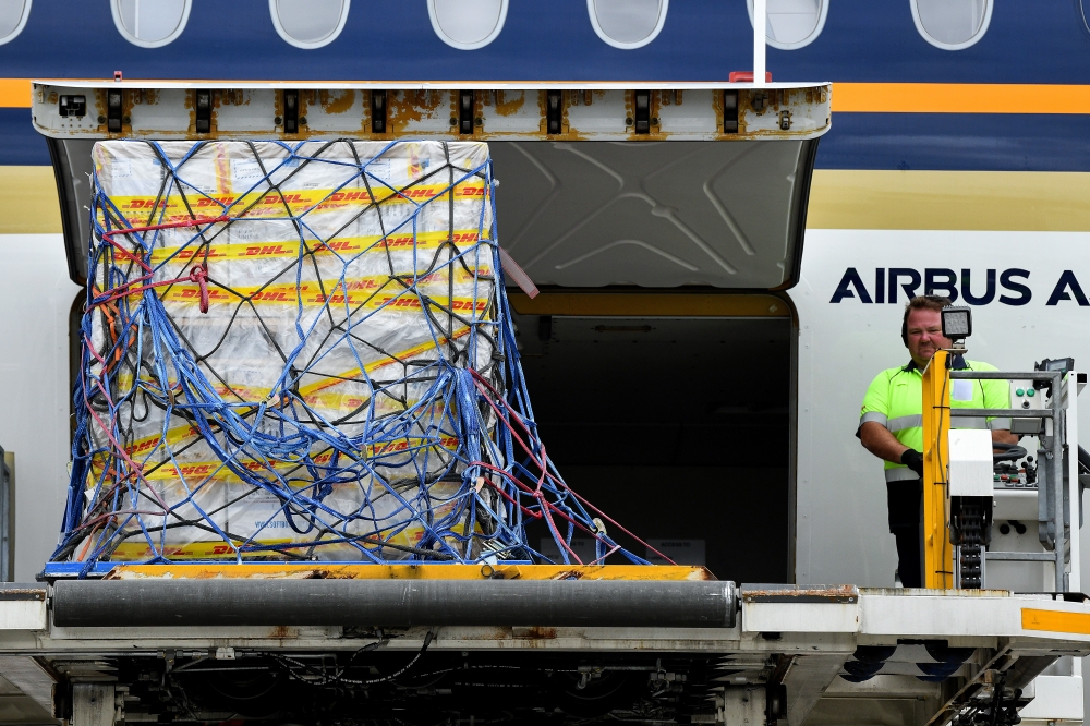 The first Australian shipment of Pfizer coronavirus disease (COVID-19) vaccines is unloaded from a Singapore Airlines plane at Sydney International Airport, Australia, February 15, 2021. AAP Image/Bianca De Marchi/via REUTERS 