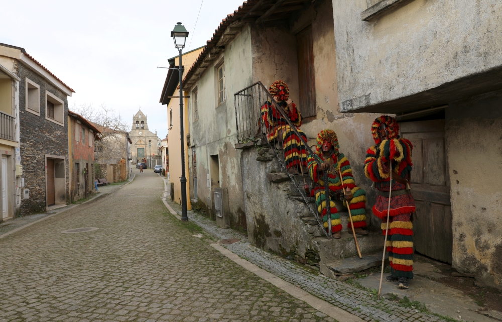 Villagers wearing traditional costumes mark the Shrovetide Sunday festival on the empty street instead of the yearly crowded carnival which was prohibited due to lockdown restrictions amid the coronavirus disease (COVID-19) pandemic in Podence, Portugal. 