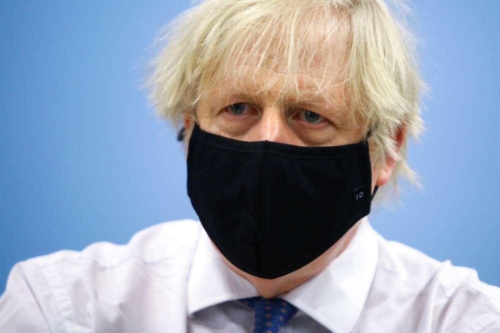 Britain's Prime Minister Boris Johnson visits a coronavirus disease (COVID-19) vaccination centre at Cwmbran Stadium in Cwmbran, South Wales, Britain February 17, 2021. Geoff Caddick/Pool via Reuters