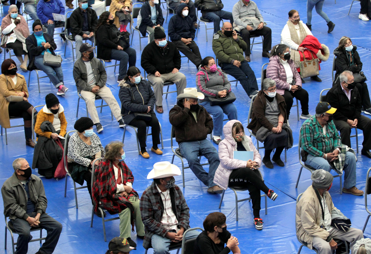 People wait seated to receive a dose of AstraZeneca coronavirus disease (COVID-19) vaccine at Municipal Gymnasium in Linares Mexico February 17, 2021. REUTERS/Daniel Becerril

