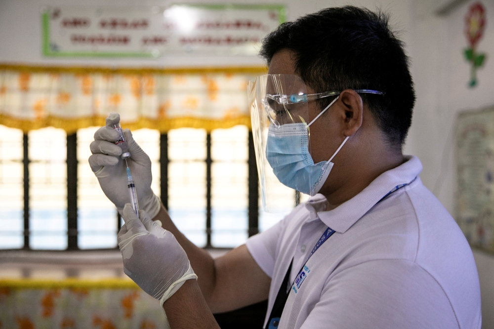A health worker participates in a simulation for COVID-19 vaccination in preparation for its arrival, at an elementary school turned vaccination command center in Pasig City, Metro Manila, Philippines, February 16, 2021. REUTERS/Eloisa Lopez/File Photo