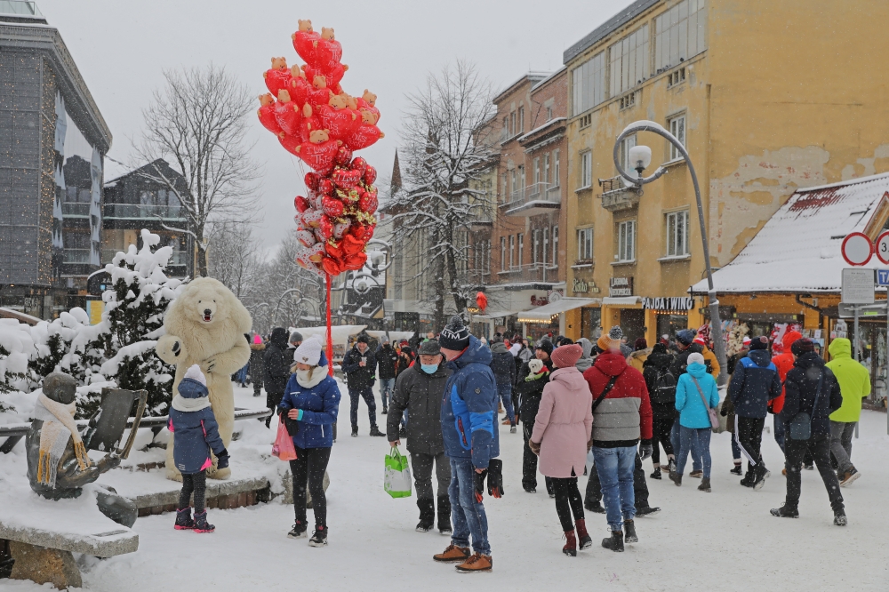 People walk in a street after the loosening of the coronavirus disease (COVID-19) restrictions in the resort town of Zakopane, Poland February 12, 2021. Picture taken February 12, 2021. Marek Podmokly /Agencja Gazeta via REUTERS