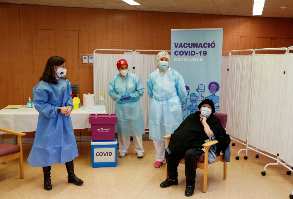 Balafia nursing home resident Milagros Garcia, 79, prepares to receive an injection with a dose of the Pfizer-BioNTech COVID-19 vaccine in Lleida, Catalonia, Spain, December 27, 2020. REUTERS/Albert Gea/File Photo