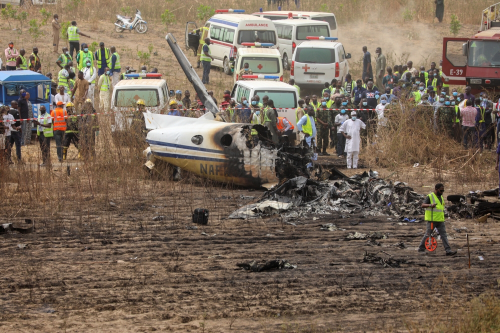 Rescuers and people gather near the debris from a Nigerian air force plane, which according to the aviation minister crashed while approaching the Abuja airport runway, in Abuja, Nigeria February 21, 2021. REUTERS/Afolabi Sotunde
