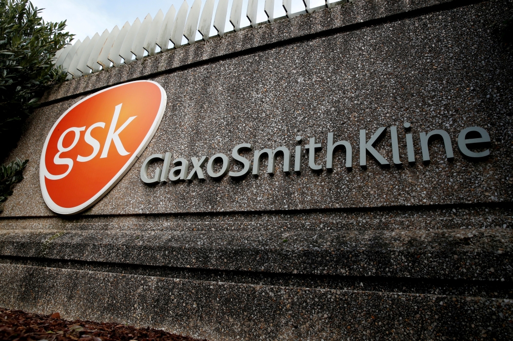 Company logo of pharmaceutical company GlaxoSmithKline is seen at their Stevenage facility, Britain October 26, 2020. REUTERS/Matthew Childs//File Photo