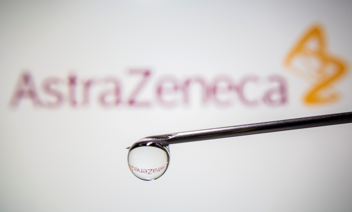 FILE PHOTO: AstraZeneca's logo is reflected in a drop on a syringe needle in this illustration taken November 9, 2020. REUTERS/Dado Ruvic/Illustration/File Photo
