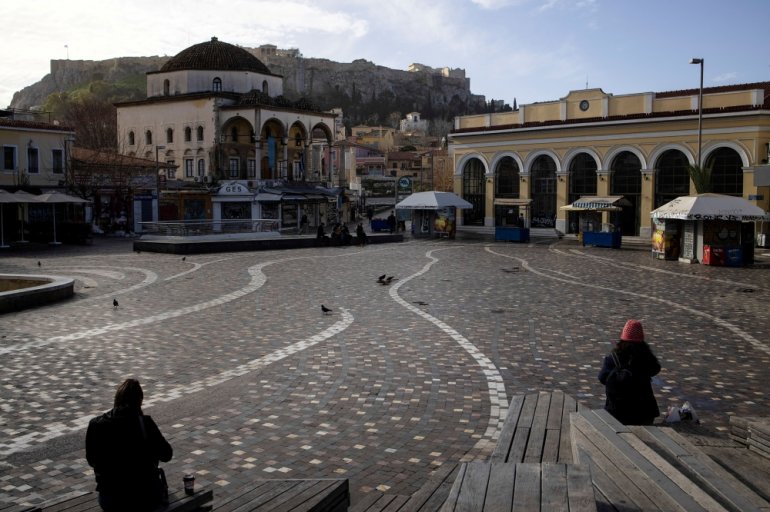 People sit in Monastiraki square after the Greek government imposed stricter lockdown measures against the coronavirus pandemic, in Athens, Greece, February 11, 2021. REUTERS/Alkis Konstantinidis/File Photo