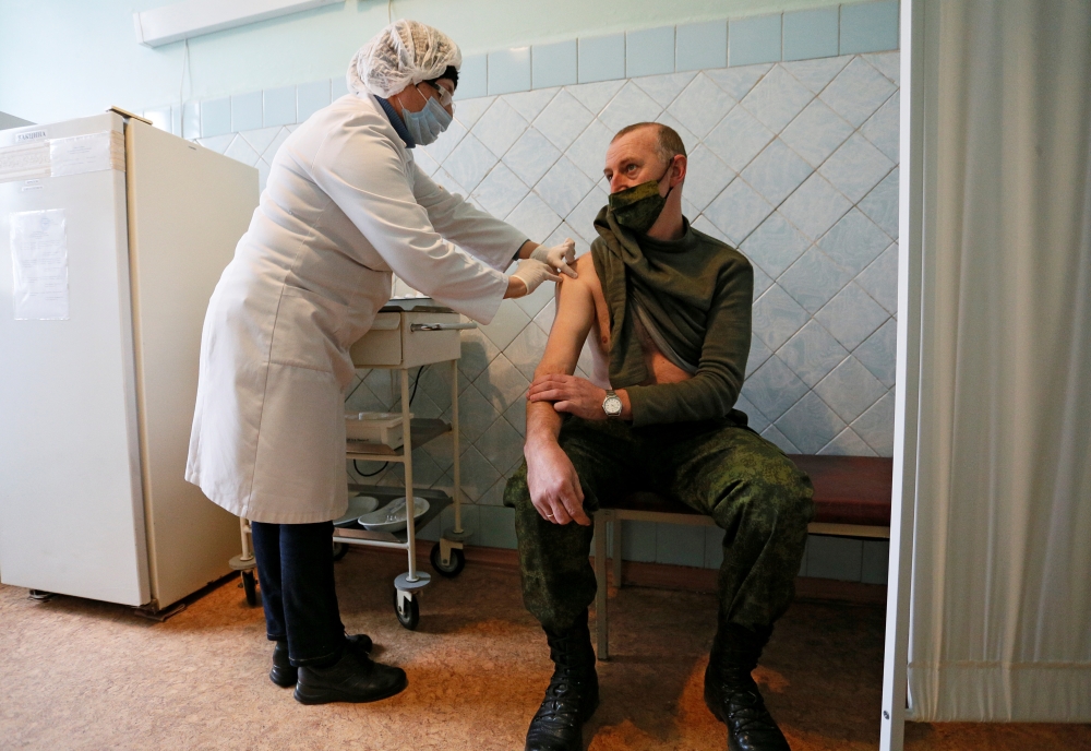 A serviceman receives a dose of Sputnik V (Gam-COVID-Vac) vaccine against the coronavirus disease (COVID-19) at a local hospital in the rebel-controlled city of Donetsk, Ukraine February 24, 2021. REUTERS/Alexander Ermochenko
