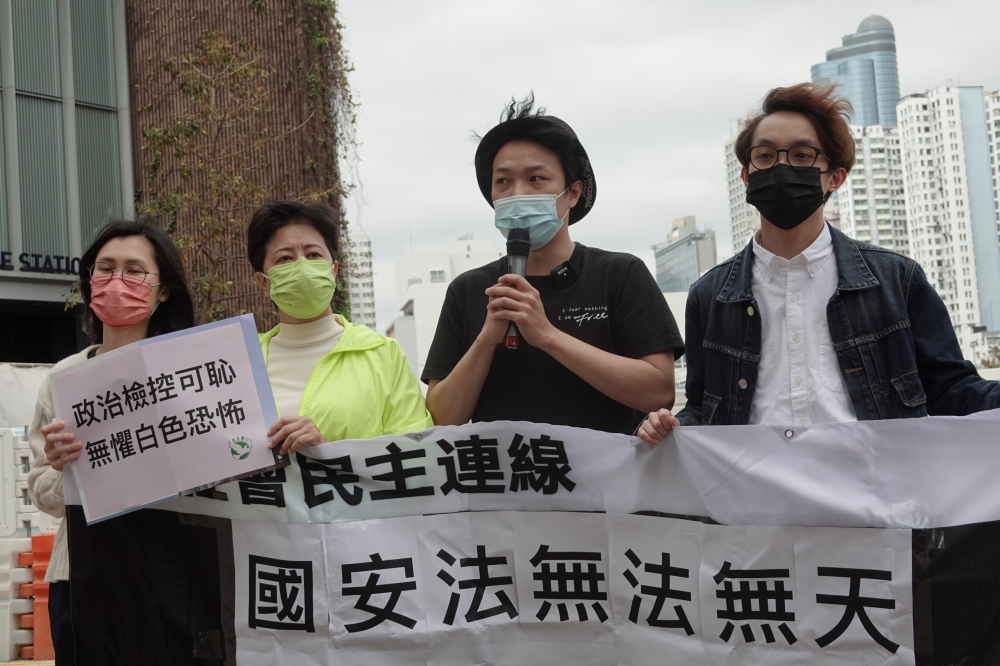 Pro-democracy activists Helena Wong Pik-wan (2nd-L) and Jimmy Sham (2nd-R) speak to the media as they arrive to report to the police station over national security law charges, in Hong Kong, China February 28, 2021. REUTERS/Joyce Zhou