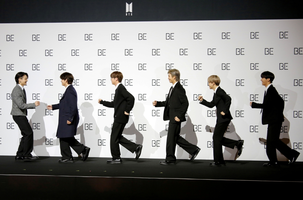 Members of K-pop boy band BTS pose for photographs during a news conference promoting their new album 