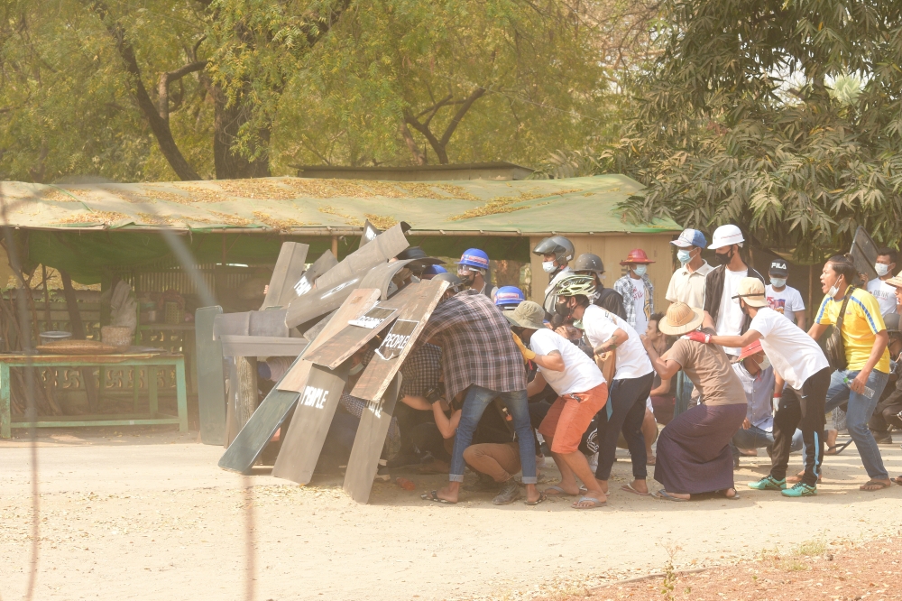 Protesters create a shield formation in Nyaung-U, Myanmar, March 7, 2021, in this still image from a video obtained from social media by Reuters.