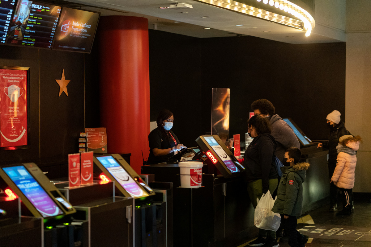 Guests purchase tickets at the AMC movie theatre in Lincoln Square, amid the coronavirus disease (COVID-19) pandemic, in the Manhattan borough of New York City, New York, U.S., March 6, 2021. REUTERS/Jeenah Moon
