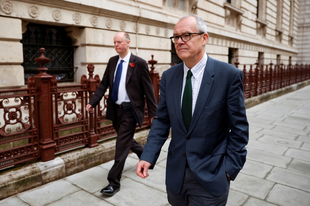 Britain's Chief Medical Officer Chris Whitty and Chief Scientific Adviser Sir Patrick Vallance leave the Foreign and Commonwealth Office (FCO) in London, Britain November 10, 2020. REUTERS/John Sibley/File Photo