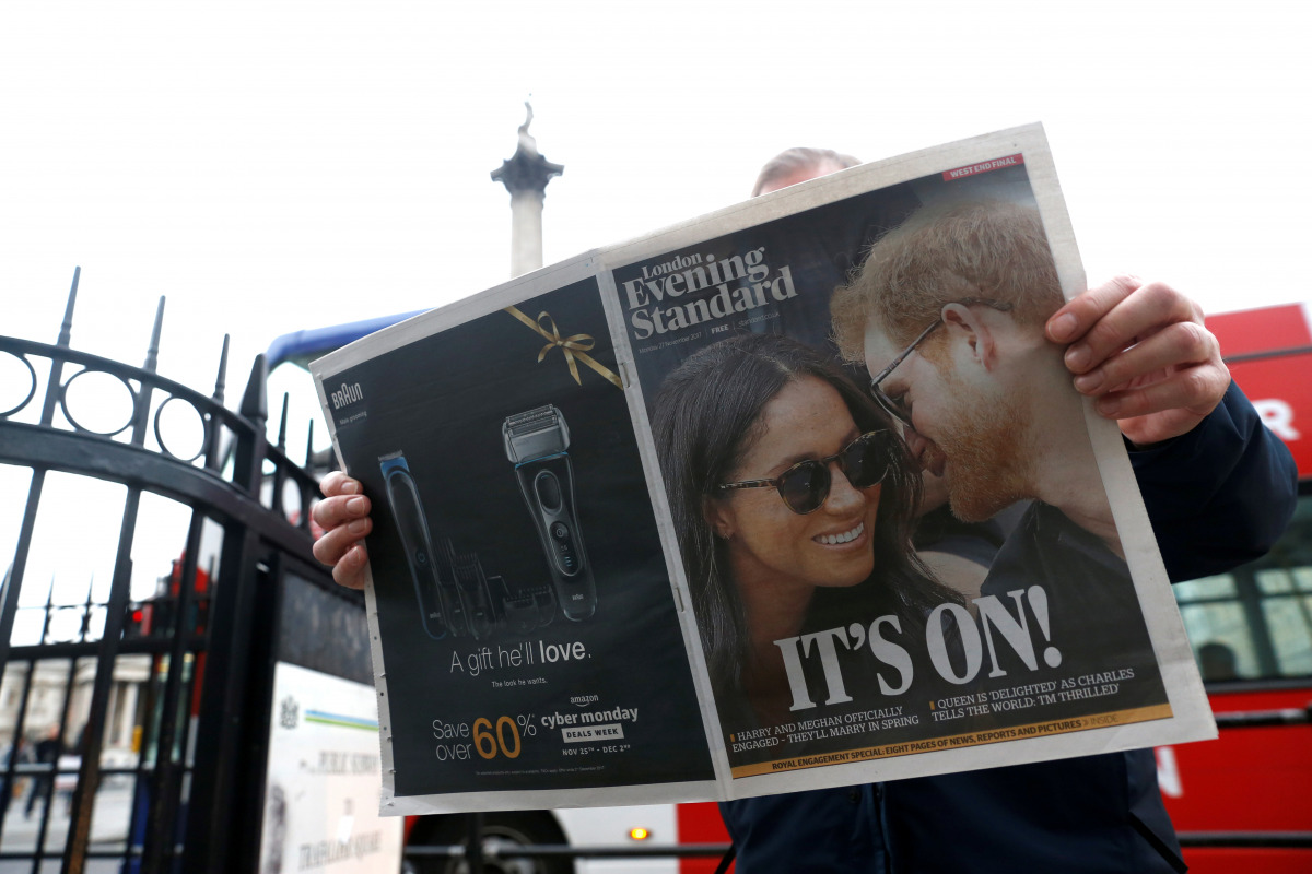 FILE PHOTO: A person is seen reading the London Evening Standard with the news that Prince Harry has announced his engagement to Meghan Markle, London, Britain, November 27, 2017. REUTERS/Darrin Zammit Lupi/File Photo
