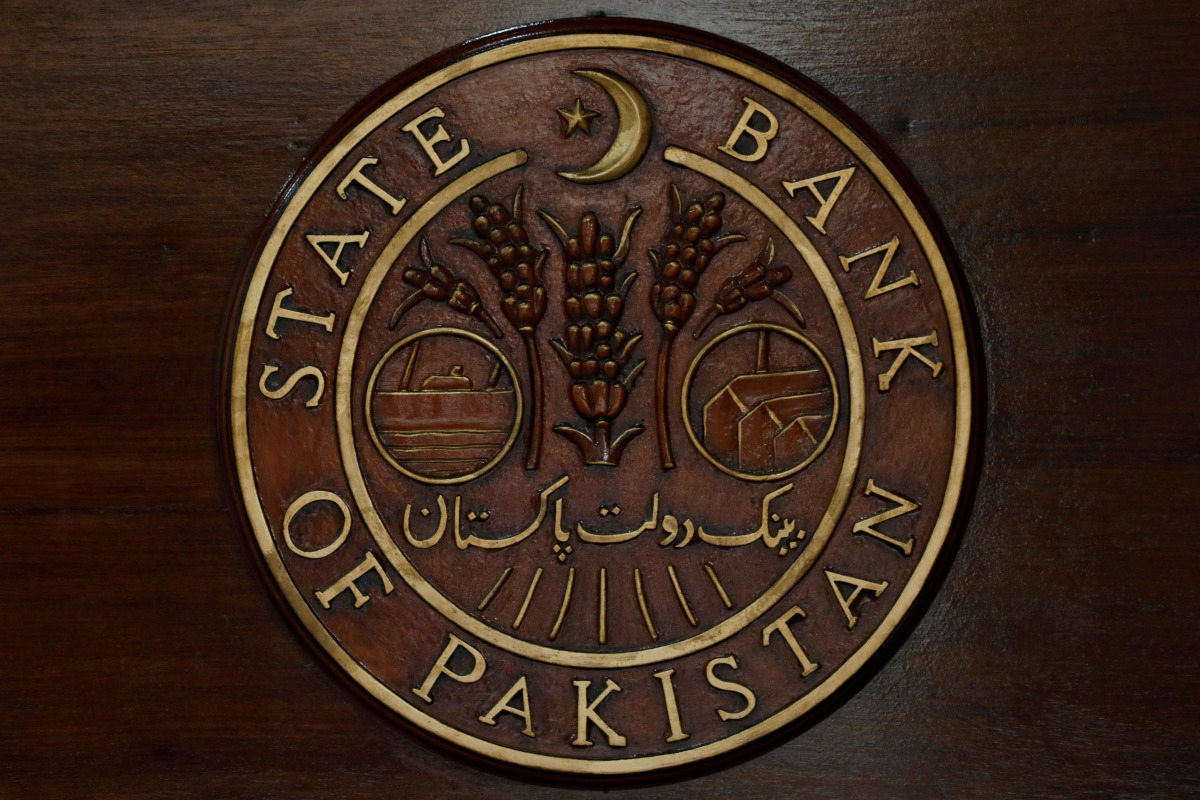 FILE PHOTO: The logo of the State Bank of Pakistan (SBP) is pictured on a reception desk at the head office in Karachi, Pakistan July 16, 2019. REUTERS/Akhtar Soomro/File Photo
