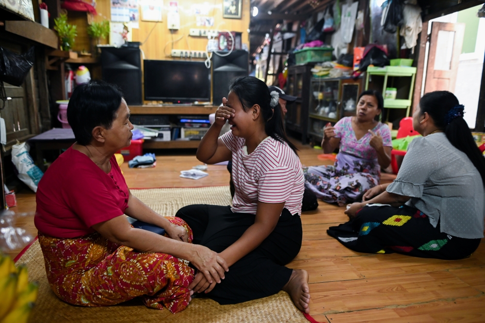 Family members of Sithu, 37, who was killed during a raid by security forces mourn at their home in Thaketa, Yangon, Myanmar March 13, 2021. Reuters/Stringer