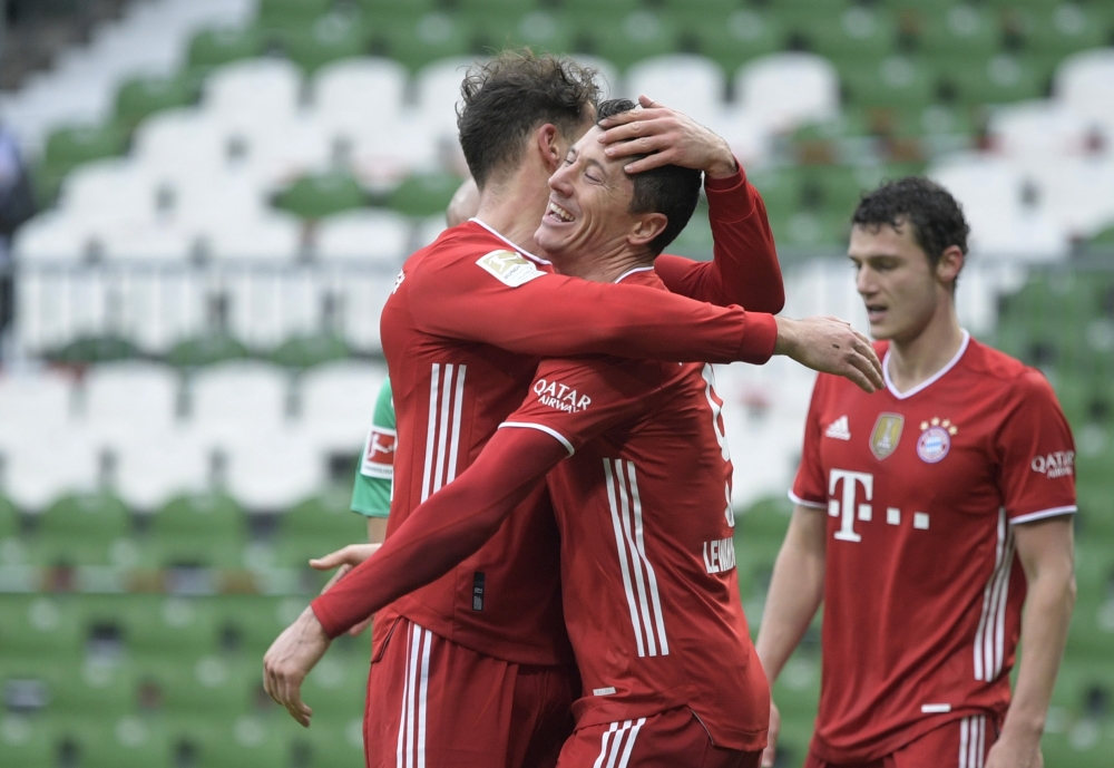 Bayern Munich's Robert Lewandowski celebrates scoring their third goal with teammate Leon Goretzka Pool via REUTERS/Fabian Bimmer