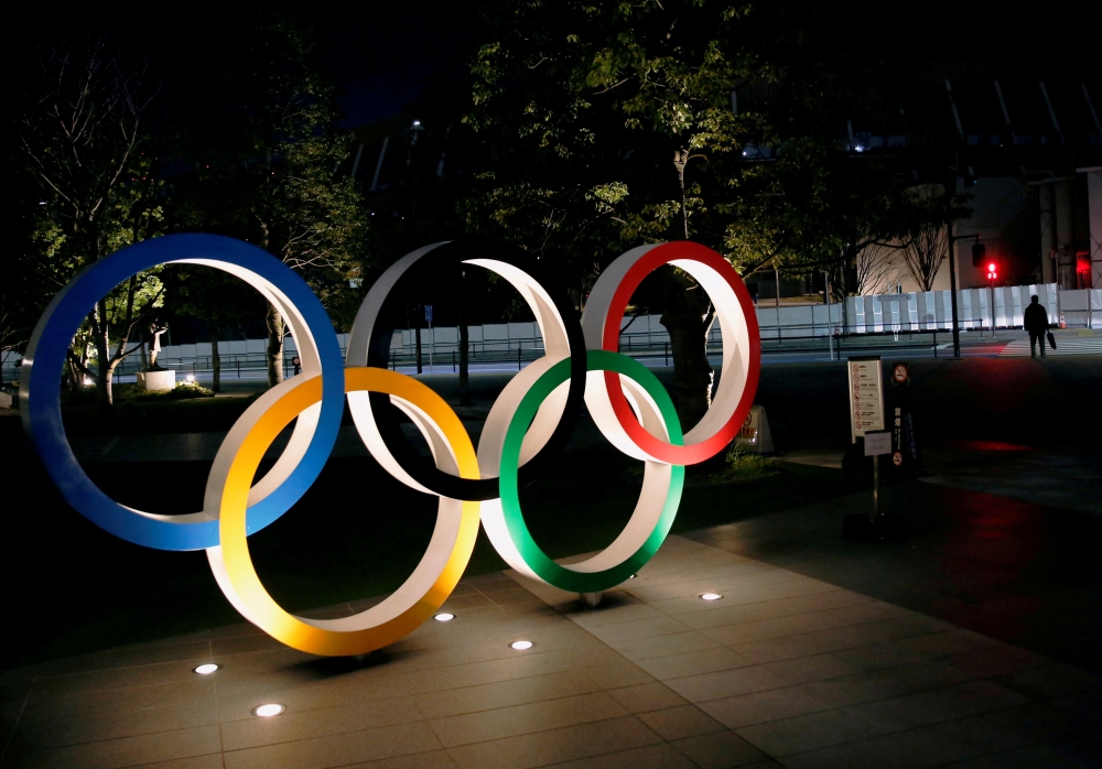 FILE PHOTO: The Olympic rings are illuminated in front of the National Stadium in Tokyo, Japan January 22, 2021. REUTERS/Kim Kyung-Hoon//File Photo