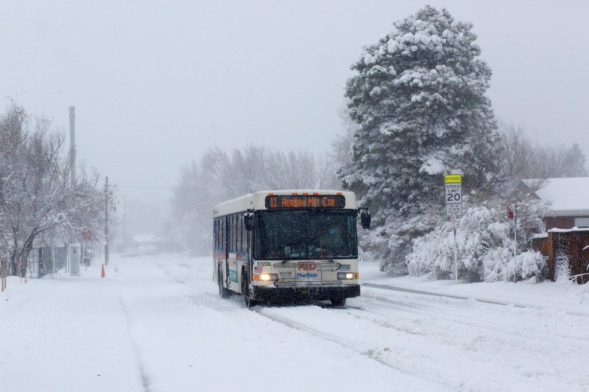 A city bus makes its way through snowy streets during a storm in DENVER, Colorado, U.S., March 14, 2021. REUTERS/Kevin Mohatt
