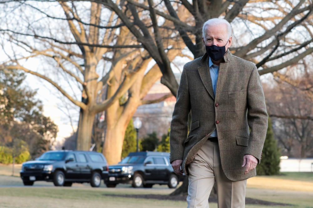 US President Joe Biden walks across the South Lawn of the White House towards reporters, in Washington, US, March 14, 2021. Reuters/Cheriss May