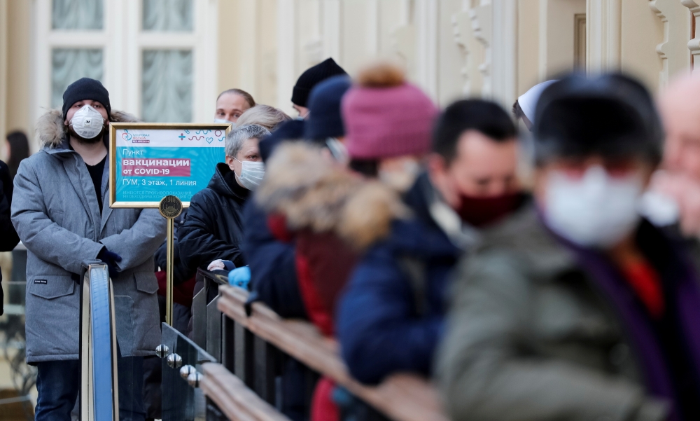 People line up to receive a dose of Sputnik V (Gam-COVID-Vac) vaccine against the coronavirus disease (COVID-19) at a vaccination centre in the State Department Store, GUM, in central Moscow, Russia January 18, 2021 REUTERS/Shamil Zhumatov/File Photo
