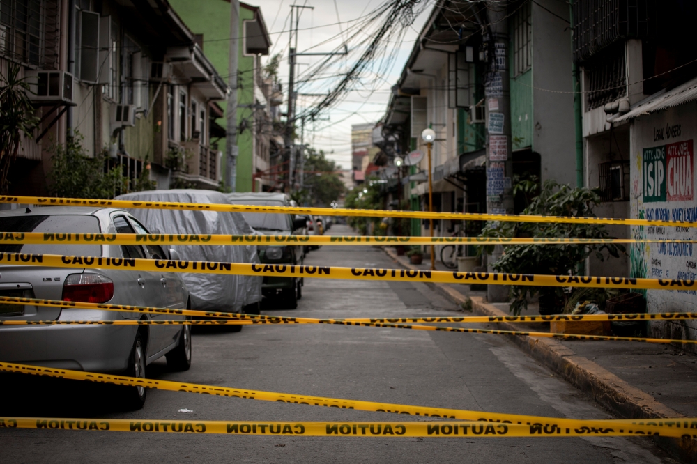 A view shows a makeshift barrier set up on a street of a village under lockdown amid rising coronavirus disease (COVID-19) infections, in Manila, Philippines, March 12, 2021. REUTERS/Eloisa Lopez