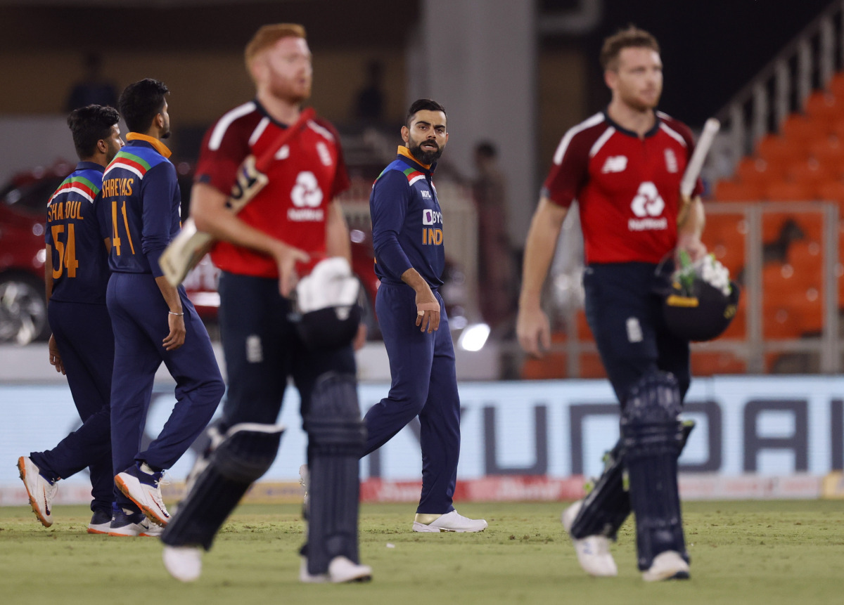 Cricket - Third Twenty20 International - India v England - Narendra Modi Stadium, Ahmedabad, India - March 16, 2021 India's Virat Kohli reacts as England's Jos Buttler and Jonny Bairstow walk off after the match REUTERS/Danish Siddiqui
