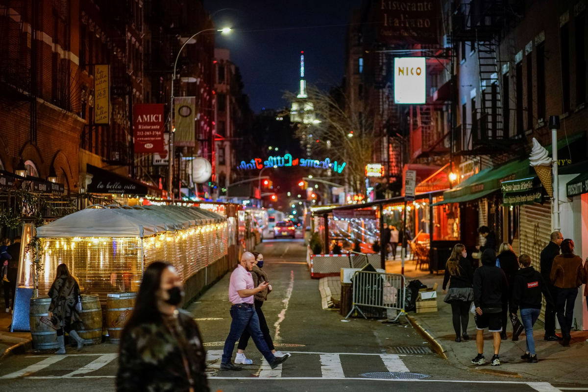 People walk around some local restaurants operating at 35 percent capacity during the coronavirus pandemic in New York City, U.S., March 11, 2021. REUTERS/Eduardo Munoz
