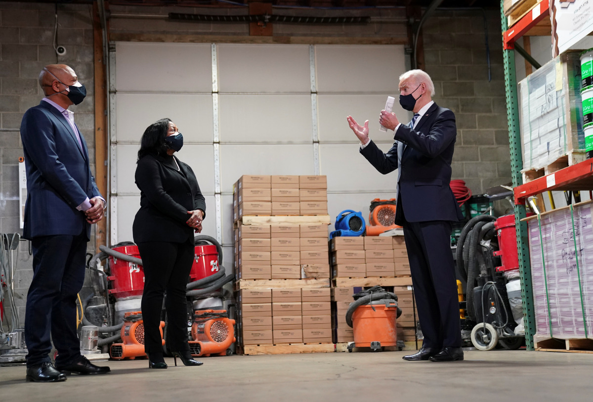U.S. President Joe Biden speaks with owners James Smith and Kristin Smith during a 