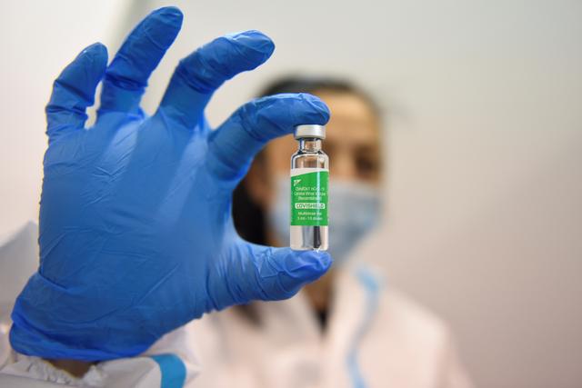 A medical worker holds a vial of the AstraZeneca vaccine against the coronavirus disease (COVID-19), during the country's mass vaccination program, in Belgrade, Serbia, March 16, 2021. REUTERS/Zorana Jevtic