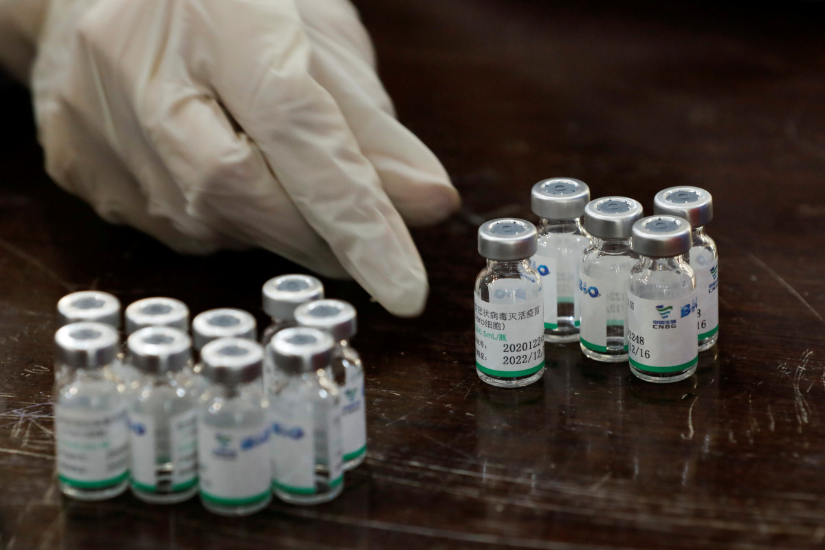 FILE PHOTO: A health worker counts used vials of Sinopharm's coronavirus disease (COVID-19) vaccine, at a vaccination centre in Karachi, Pakistan February 11, 2021. REUTERS/Akhtar Soomro/File Photo
