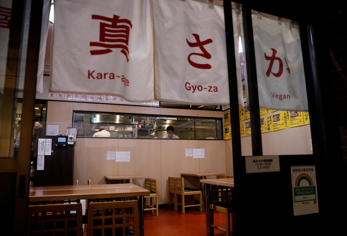 Vegan izakaya restaurant Masaka's manager Yuta Namekawa works in the kitchen as the restaurant is empty during the dinner hour in Tokyo, Japan, March 2, 2021. Picture taken March 2, 2021. REUTERS/Kim Kyung-Hoon

