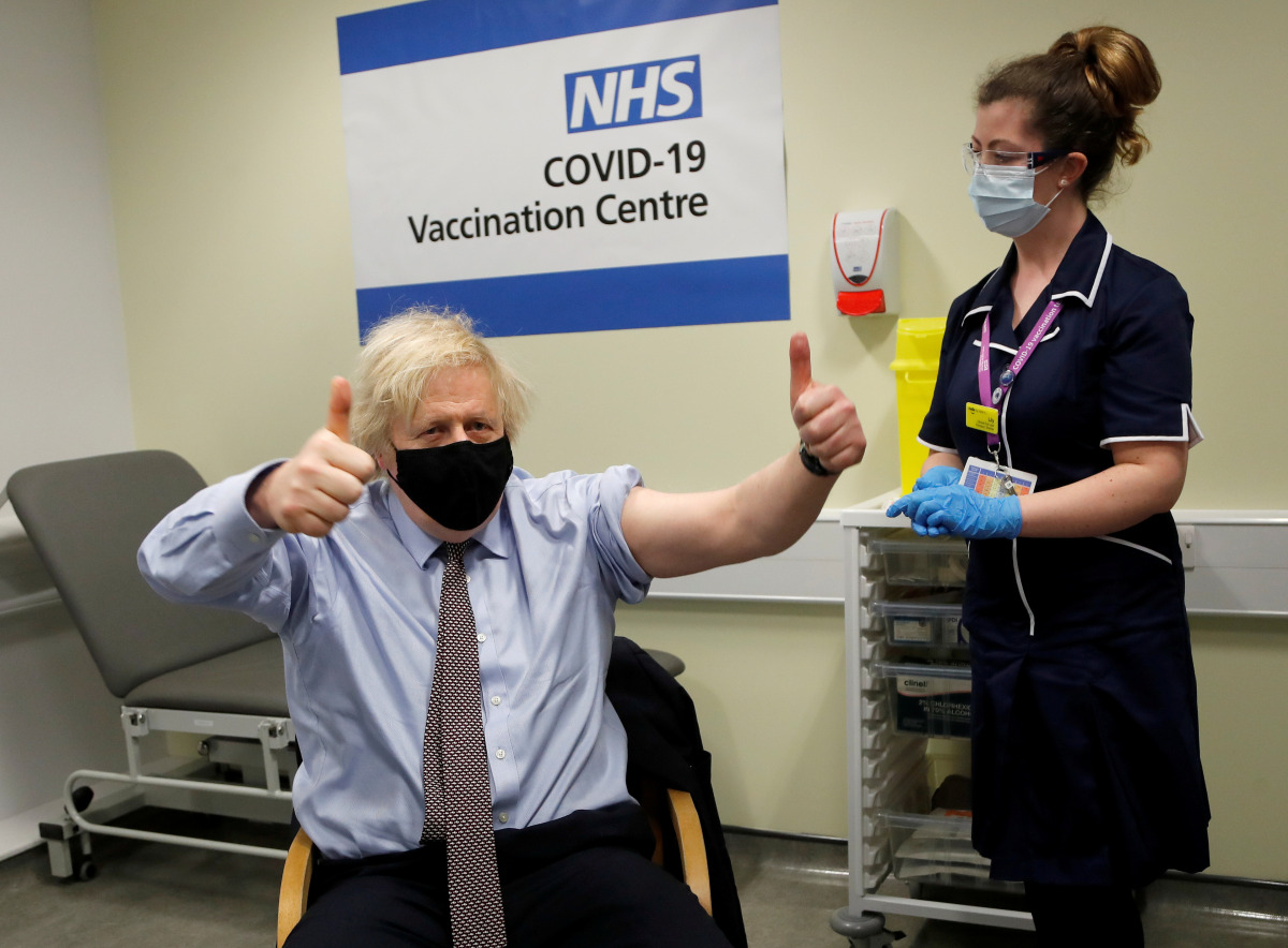FILE PHOTO: British Prime Minister Boris Johnson reacts after receiving a dose of the Oxford/AstraZeneca COVID-19 vaccine, amid the coronavirus disease pandemic, in London, Britain March 19, 2021. Frank Augstein/Pool via REUTERS/File Photo
