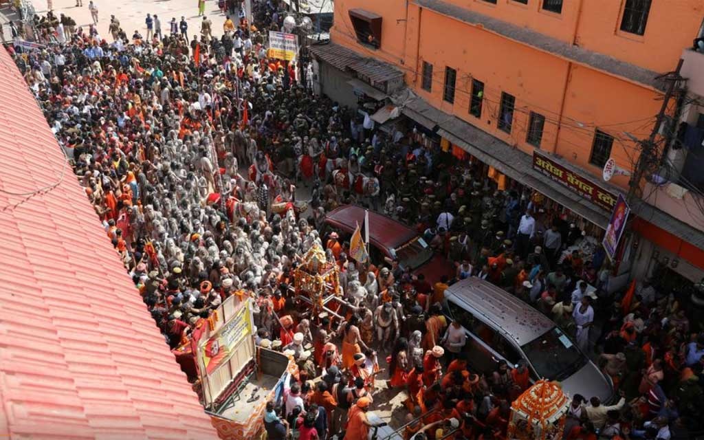 Naga Sadhus, or Hindu holy men, leave the banks of the Ganges river after the first Shahi Snan at 