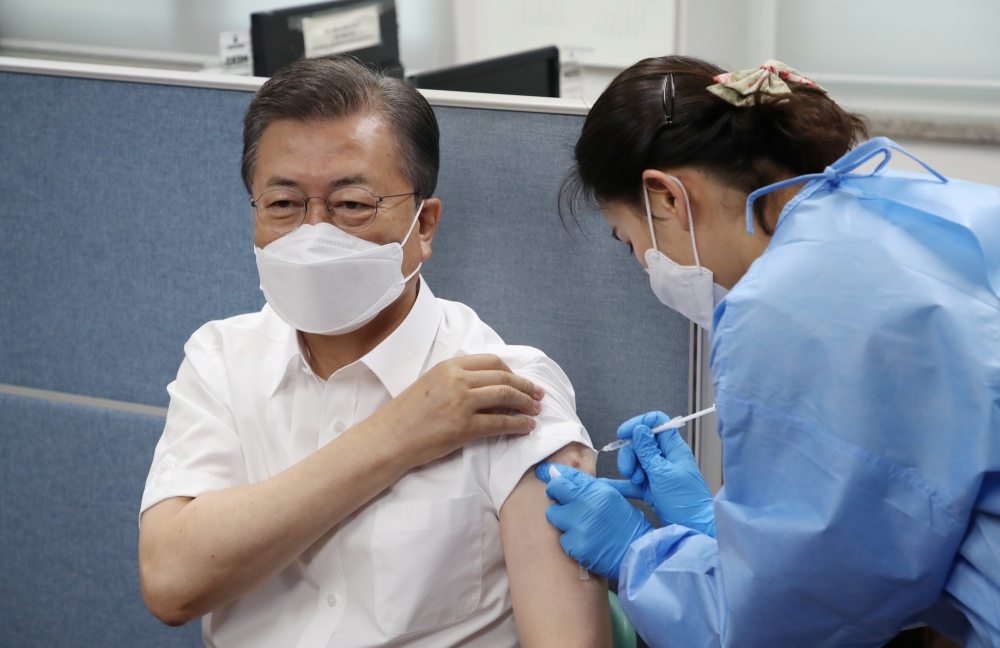 South Korean President Moon Jae-in receives a coronavirus disease (COVID-19) vaccine in Seoul, South Korea, March 23, 2021. Yonhap via REUTERS