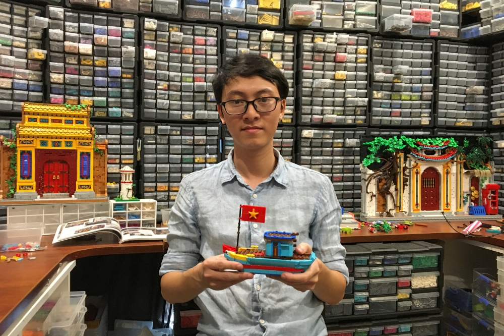 Hoang Dang, an industrial designer who loves Lego since he was a child poses in front of his pieces at his home in Hanoi, Vietnam March 13, 2021. Picture taken March 13, 2021. REUTERS/Minh Nguyen