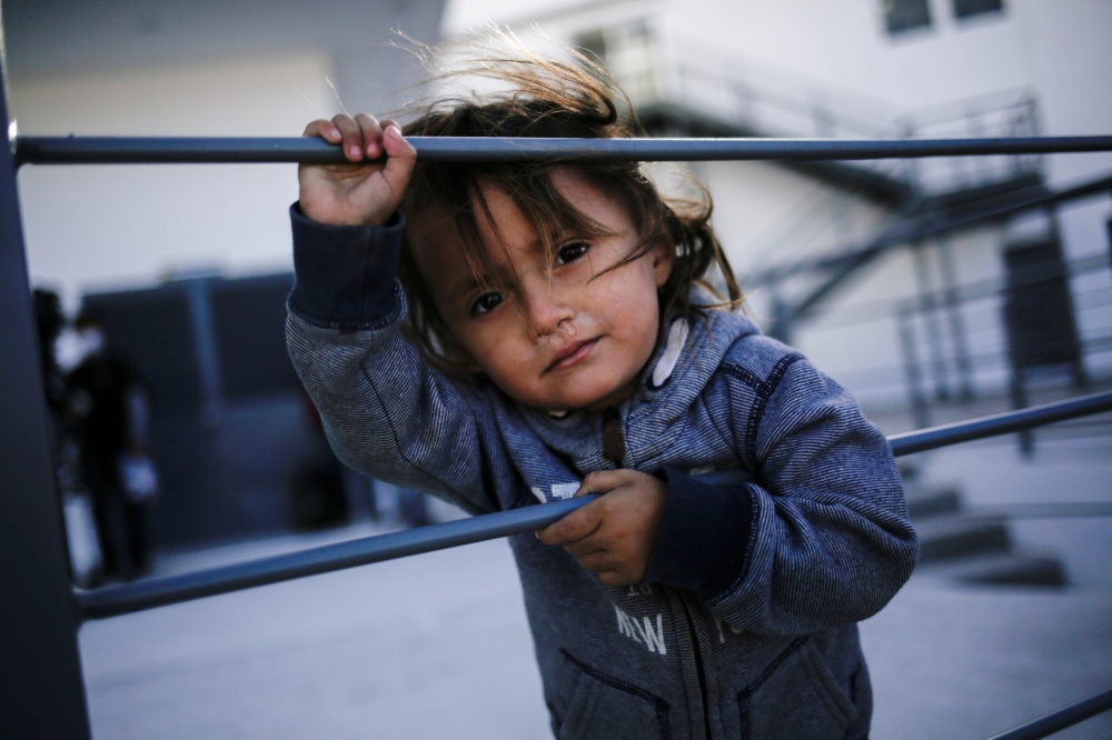 An asylum-seeking migrant girl from Central America, who was airlifted from Brownsville to El Paso, Texas, and deported from the U.S. with her mother, looks on outside the office of the Center for Integral Attention to Migrants (CAIM) in Ciudad Juarez, Me